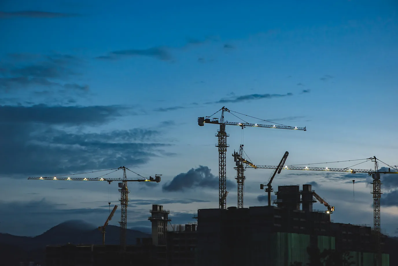 What factors are driving the transformation of the construction and real estate sectors by technology advancements?