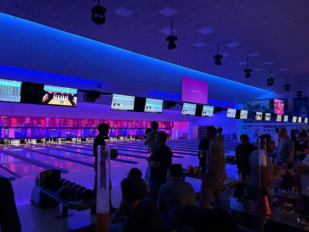 Team at a bowling alley with blue lighting