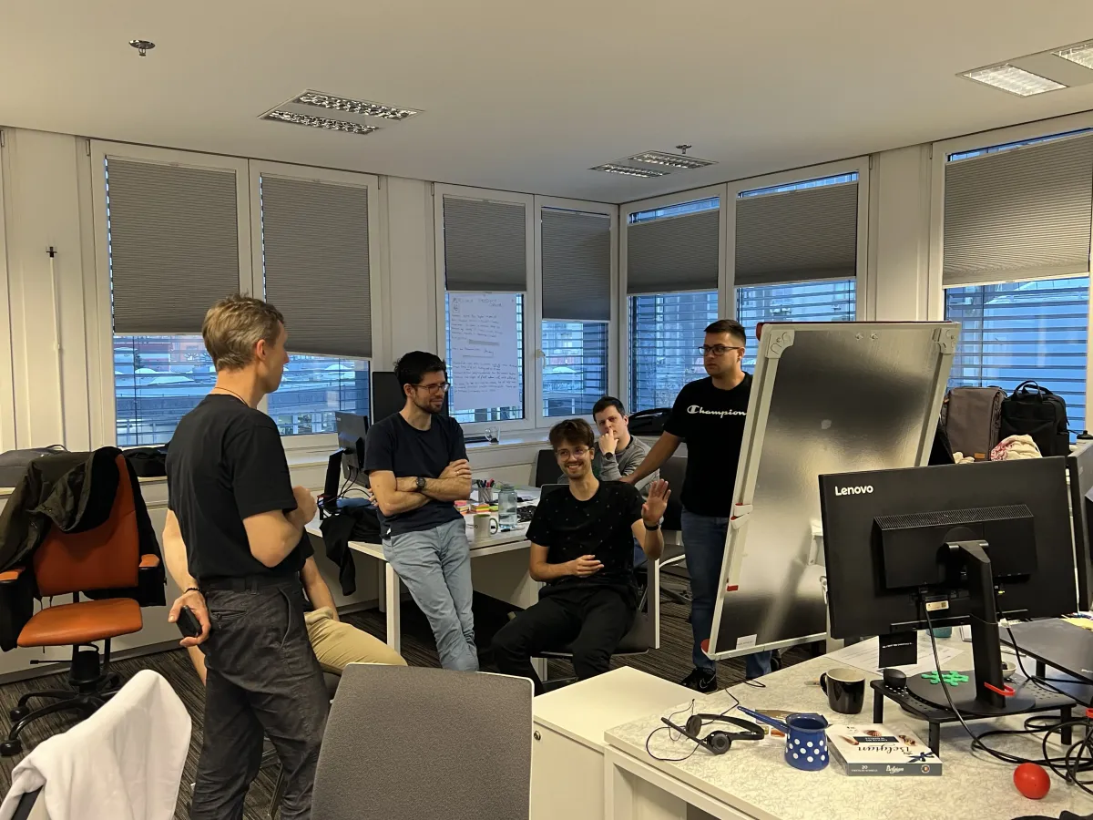 Team collaborating around a whiteboard